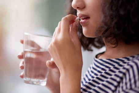 woman taking medication