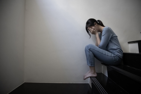 sad woman on stairs