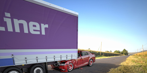 A red coupé/sedan against the back of a big truck.