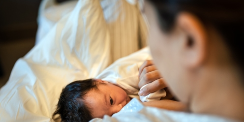 mother cradling newborn