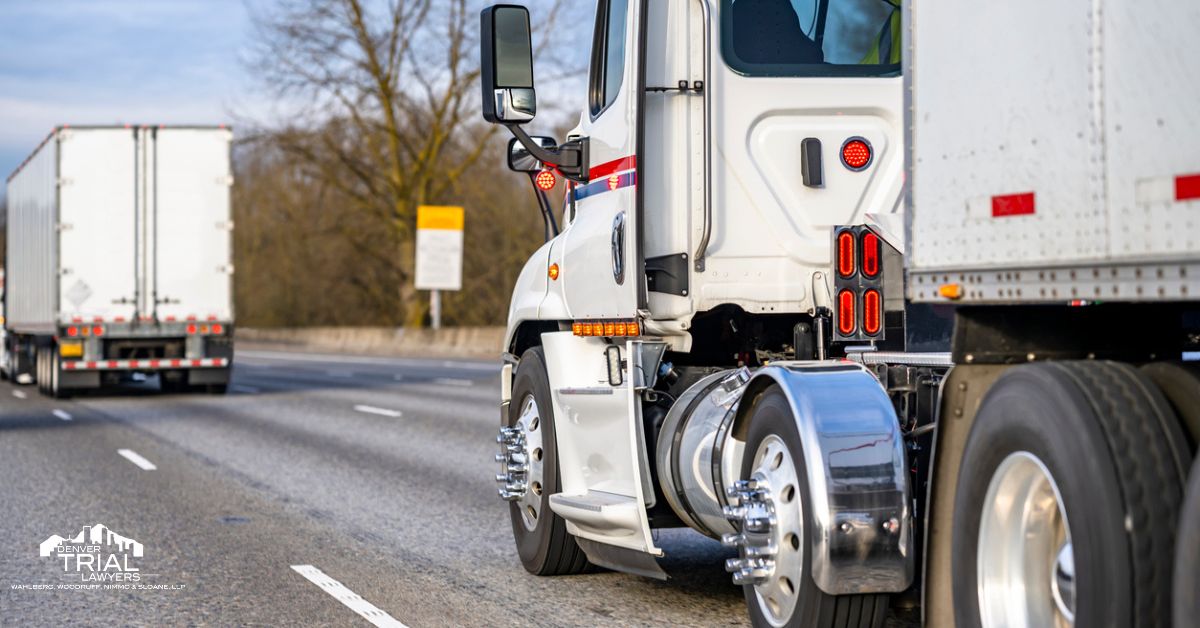 Two large semi-trucks on the road.