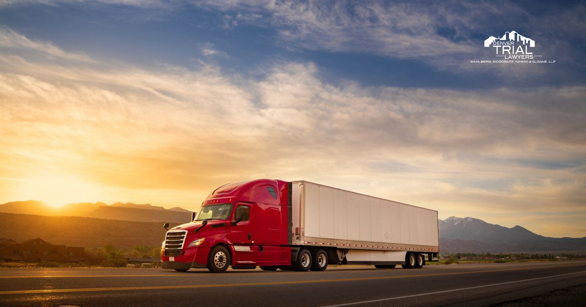 Red semi truck with white trailer on a highway.