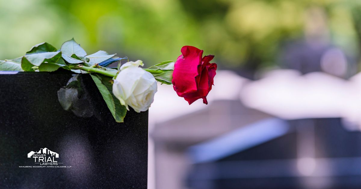 White and Red rose on top of a grave headstone.