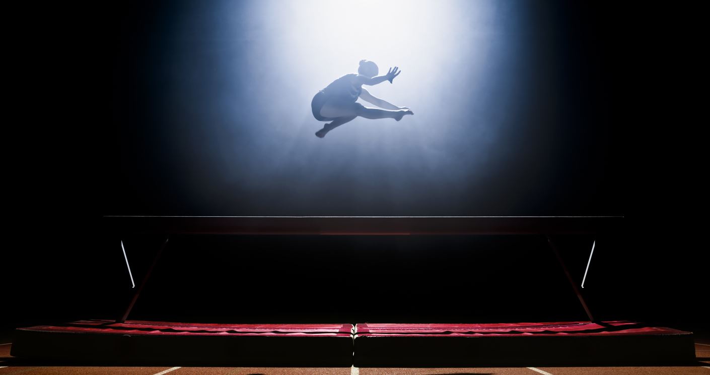 Female gymnast performing on balance beam